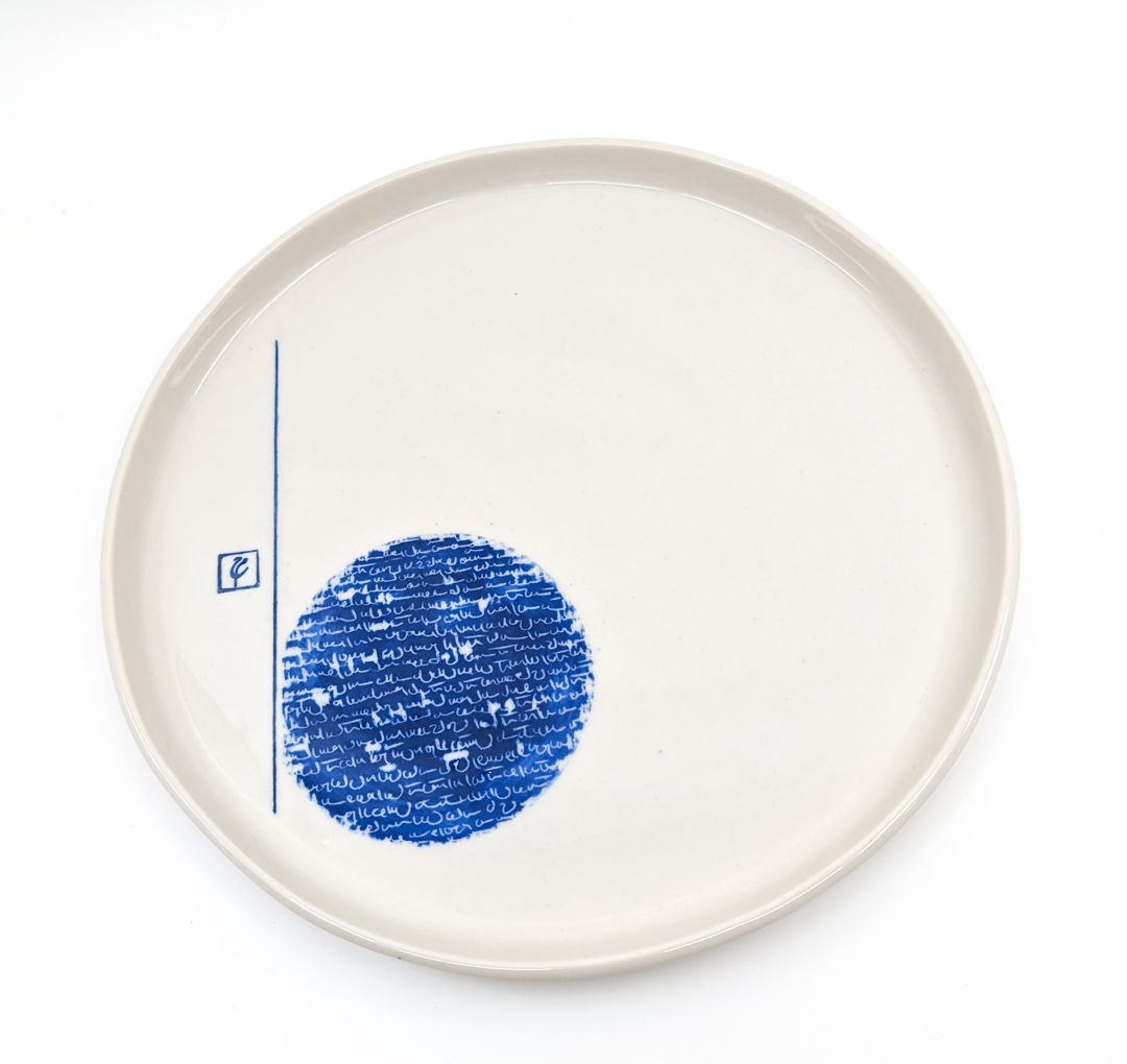 White tray decorated with blue persian writing.