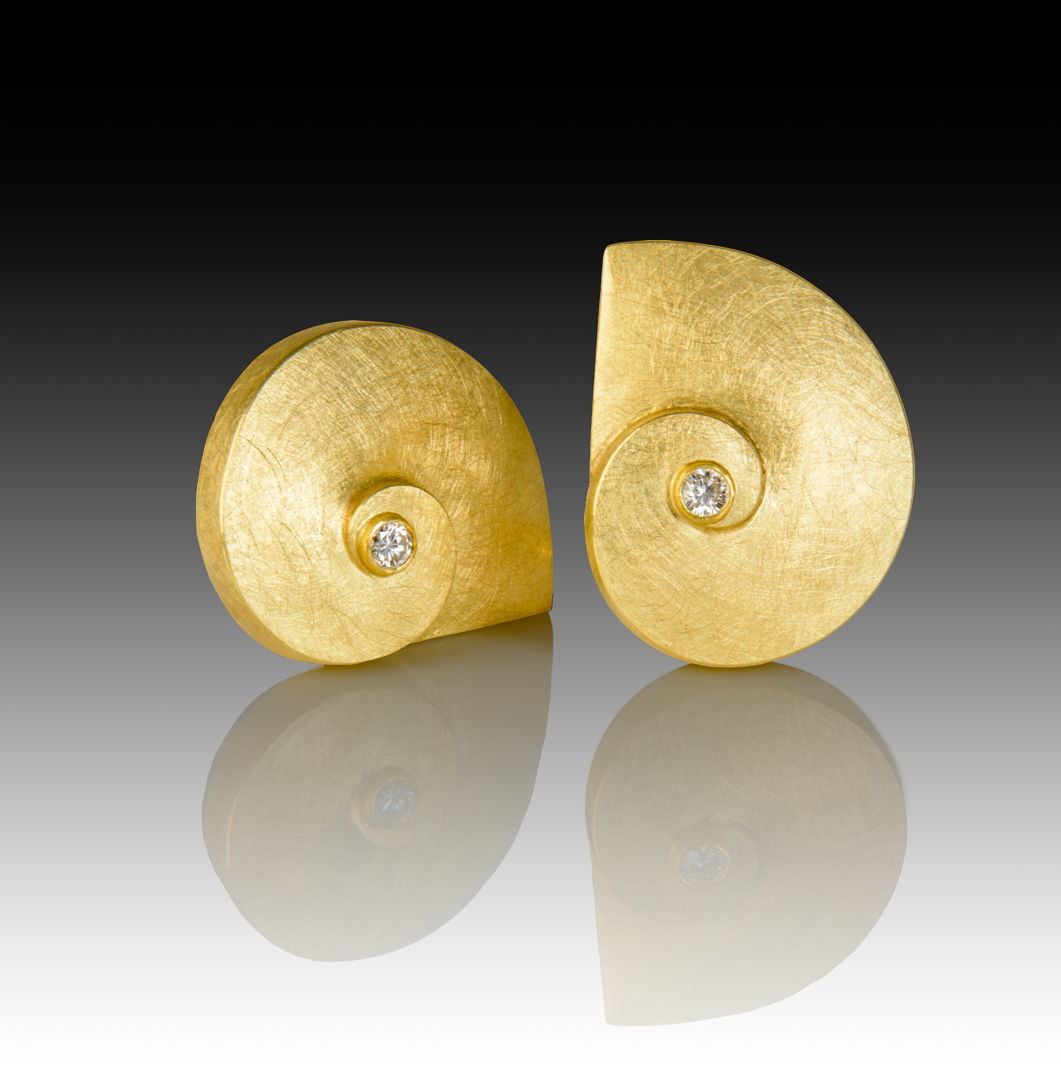 18k gold "nautilus" spirals with white round SI 3mm diamond set at center in 22k gold bezel  on post.
