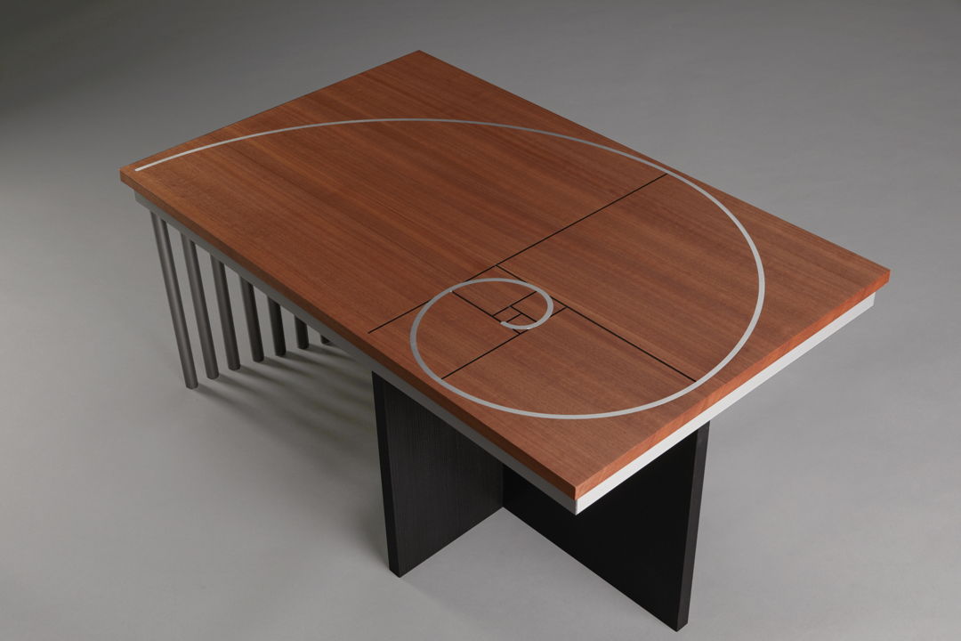 The Greek letter Phi represents the golden rectangle ratio of length to width  used here to proportion the Phi coffee table. Inlaid aluminum spiral and black grooves in a solid makore top. Ebonized ash and aluminum base. Limited edition of 8