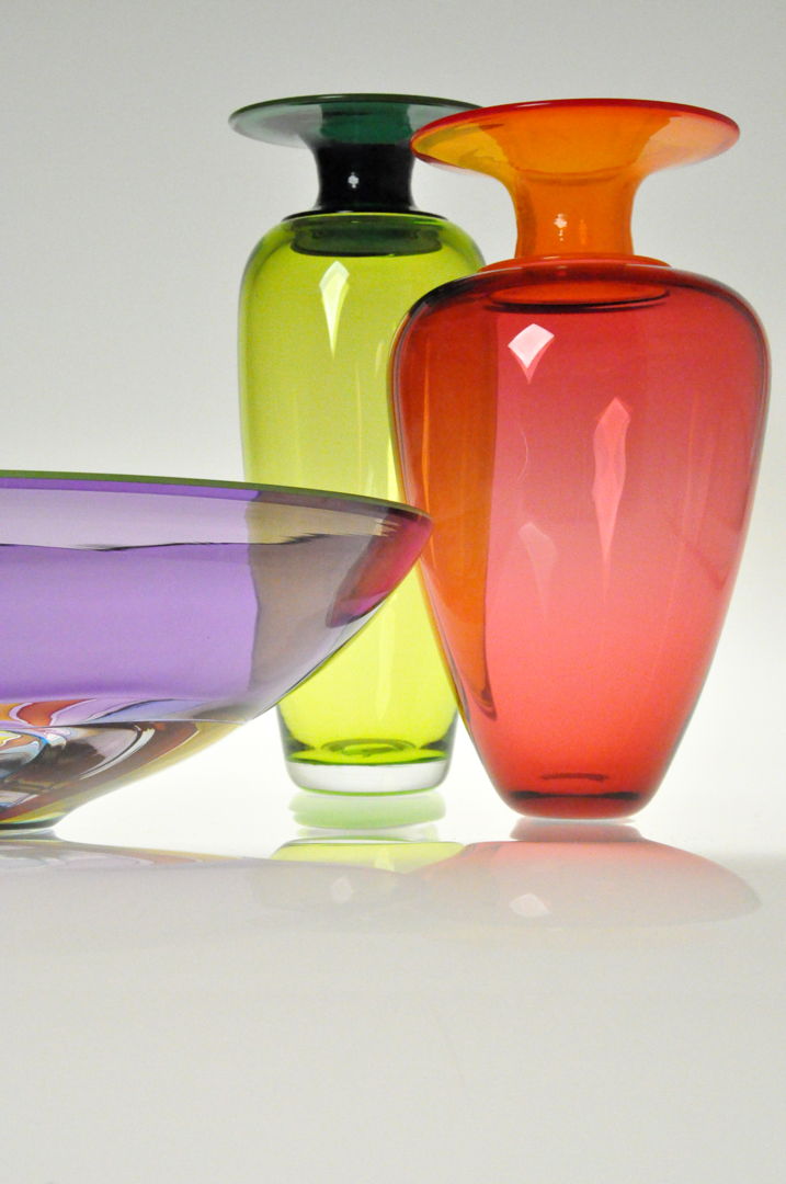Blown Glass Vessels in transparent colored glass. These pieces are made by joining different sections of colored glass while hot  each finished with contrasting colored glass lip wraps.