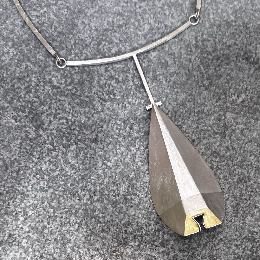 This piece is hand-fabricated and hollow formed from Sterling Silver sheet and 18kt bimetal. The piece is sanded and textured for for a more three- dimensional effect. Sterling silver square rod is also incorporated. One of a kind.