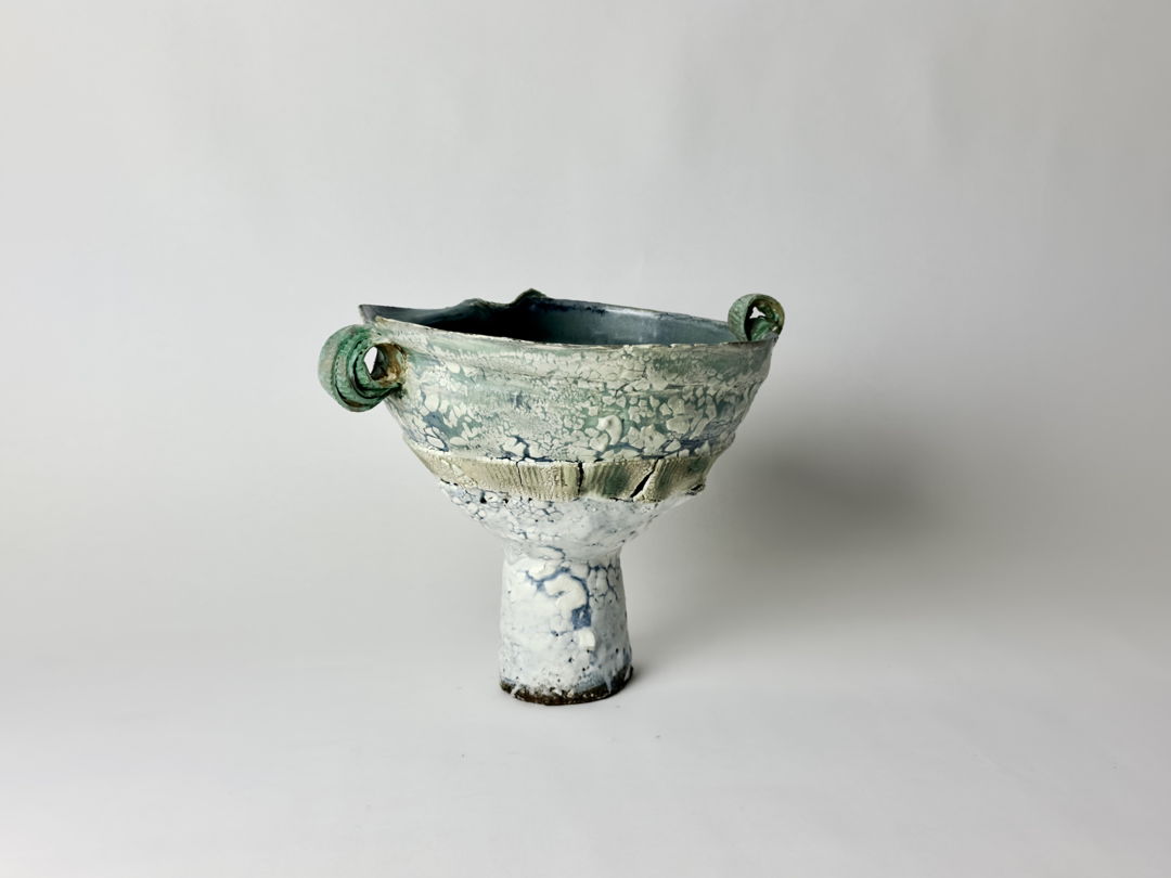Wheel-thrown and altered stoneware and porcelain ceramic with slips and glazes.