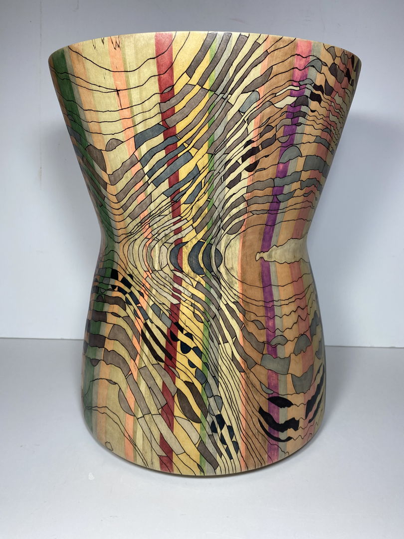 This hourglass form  made from maple  had such powerful grain lines that I had to make this central to my design. Hidden beneath the grain lines emerged numerous egg forms that remain discreetly embedded throughout the form