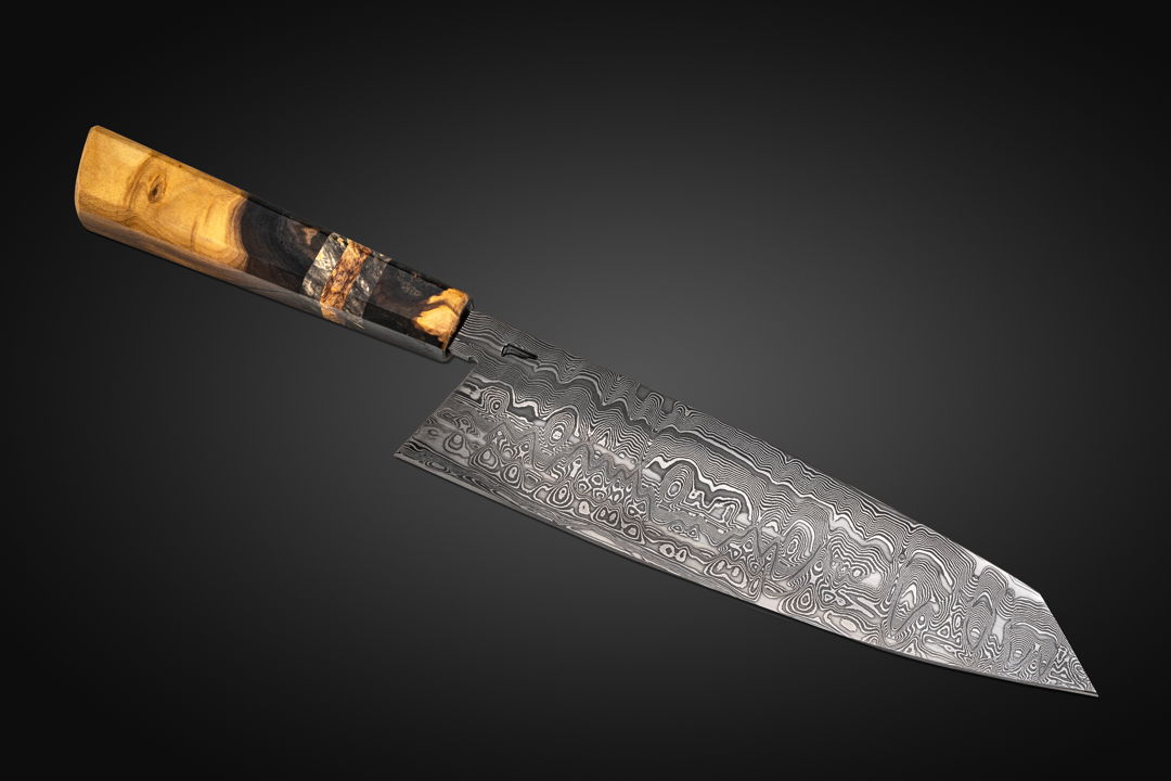 My eight in chef  the Damascus is diffusion bonded by me from 26C3 and 15N20 steels. The handle is made from Smoky Mountains Poplar with dyed maple burl accents