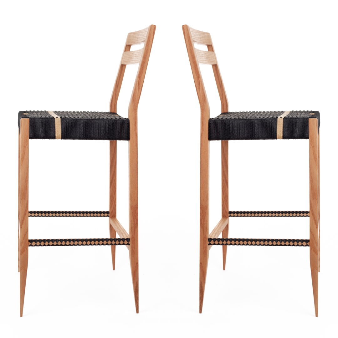 barstool made from white oak and a seat woven with two colors of danish cord  side rungs are carved on the bandsaw and details highlighted with black paint.