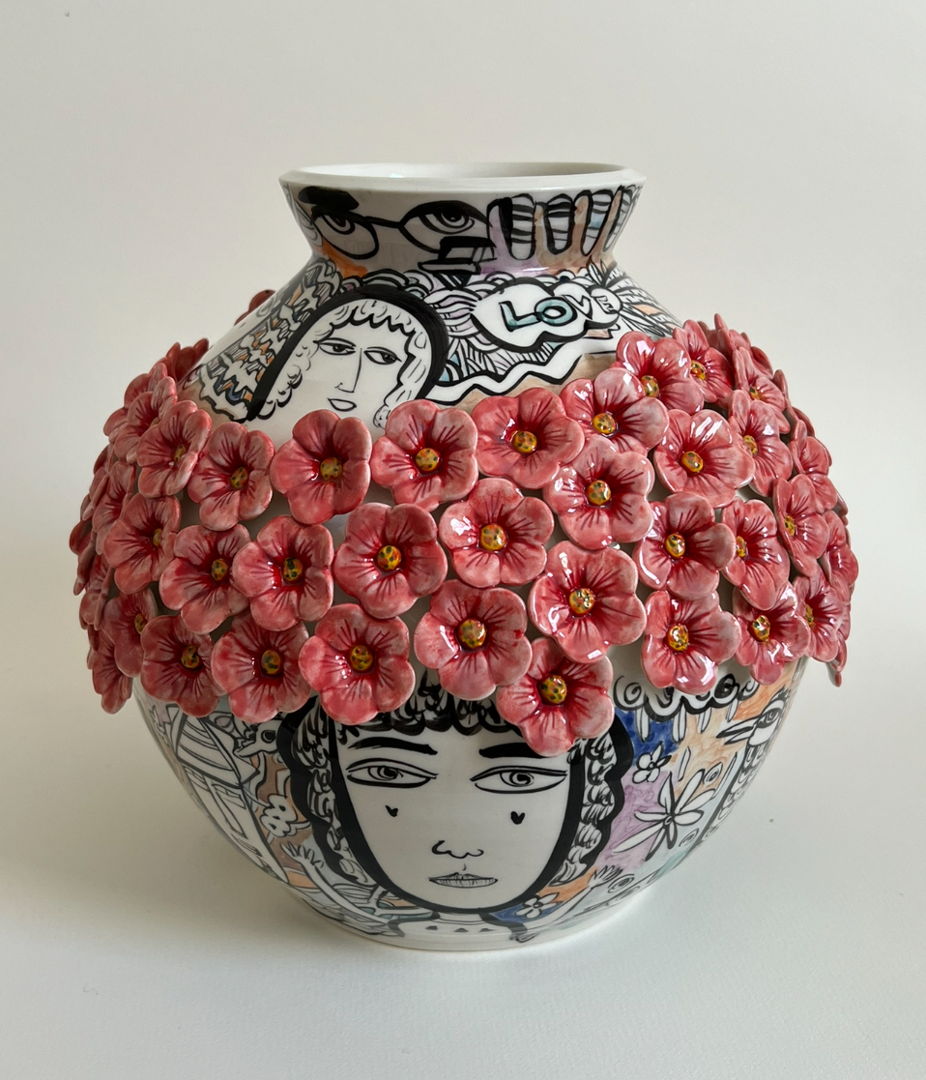 Porcelain vase with ring of red flowes around the widest part. Graphic illustrations with strong black lines fill the rest of the space.