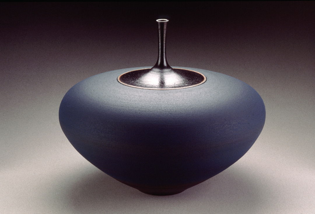 Thrown  terracotta vase. Black neck is shiny and the lower part of the vase is blue and matte.