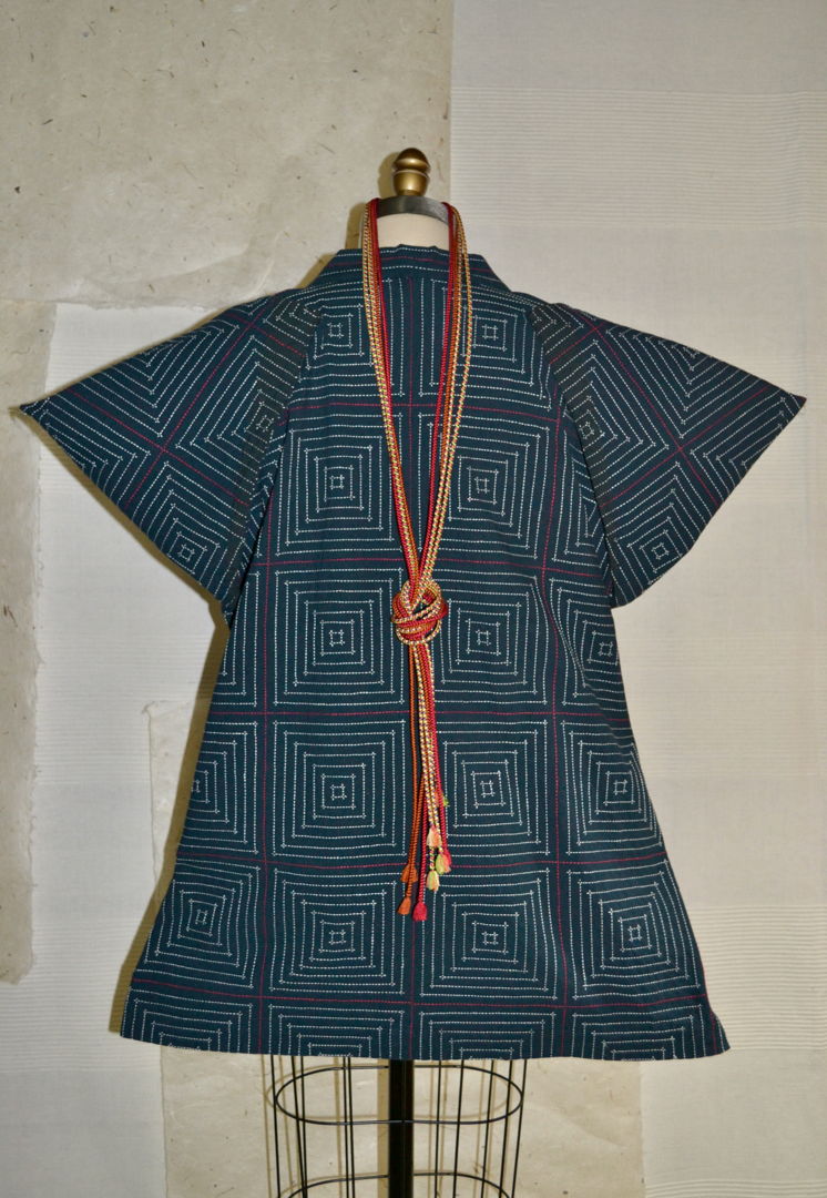 Masu is the Japanese word signifying prosperity or brilliance. This jacket contains an abundance of straight running stitches  but in a design that evokes strength and elegance. The fabric was naturally dyed from indigo plant  accompanied by plant-dyed thread using madder and other native plants.