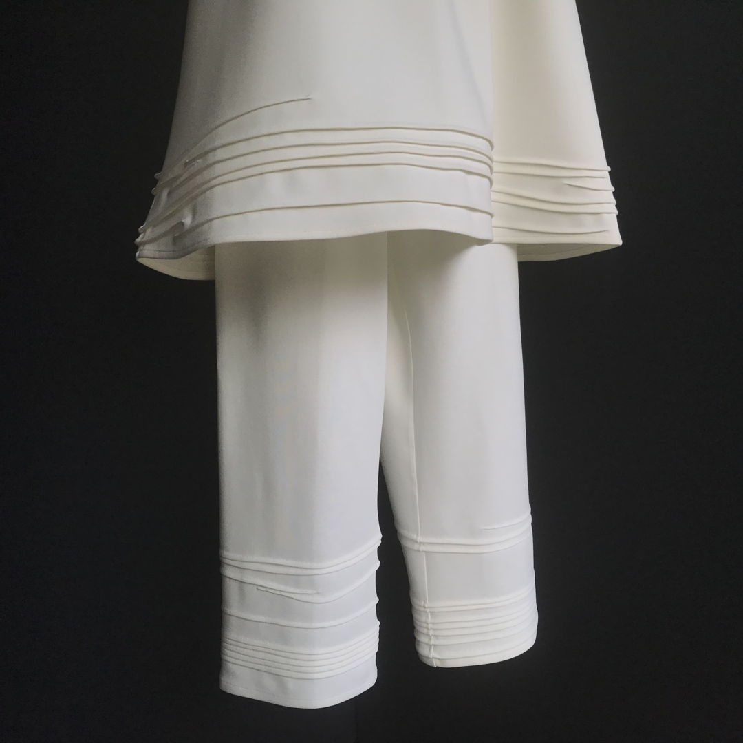 Horizontal details created by folding and stitching.