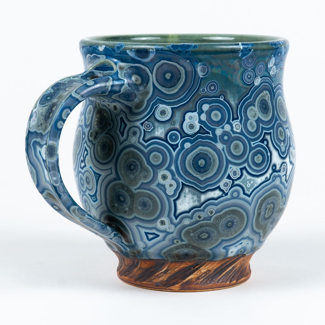 Blue mug with crystalline glaze body and base made to look like wood