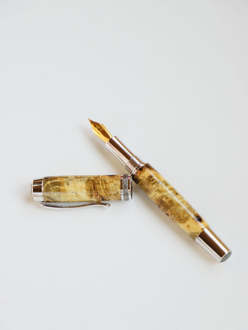 A fountain pen made of reclaimed wood from California.