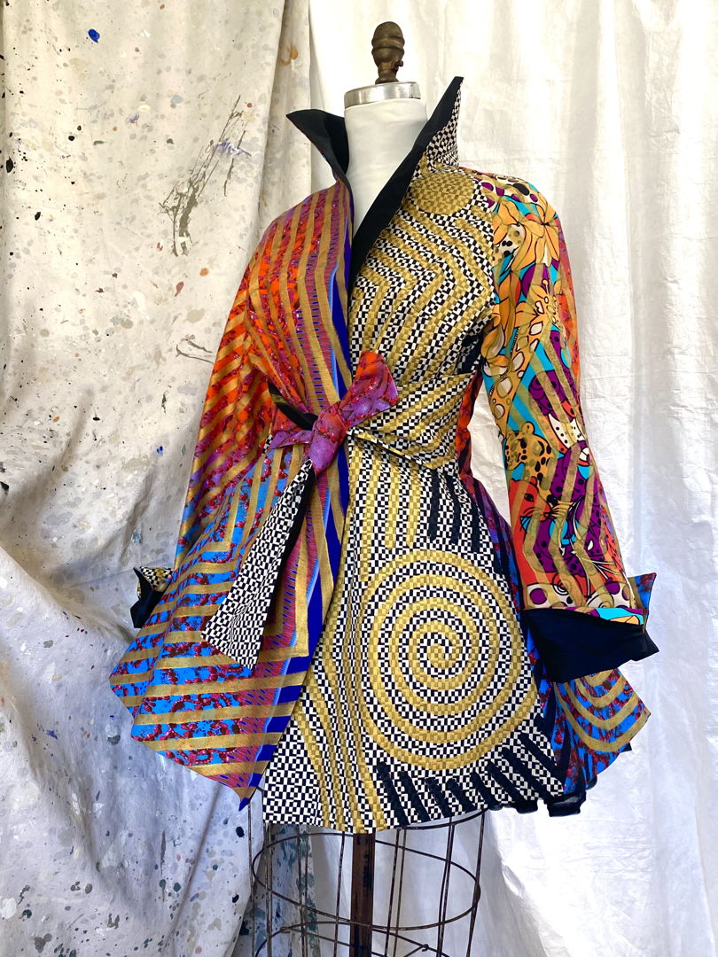 Every inch of fabric is hand painted with graphics done with a 3/8" brush. The results are mesmerizing on both solid and woven pattern fabrics. Each piece is carefully planned out for placement is everything. After painting  all panels are assembled and finished by the artist.