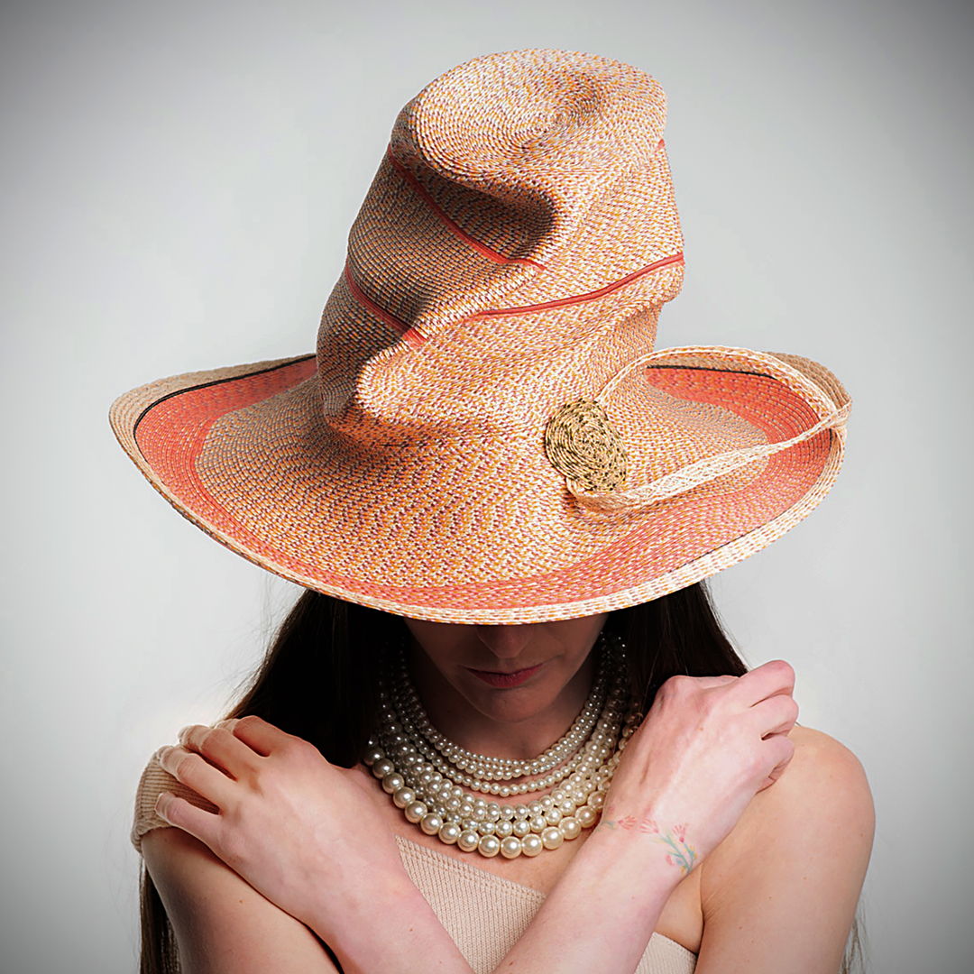 This piece is stitched from a very narrow Swiss braid  of synthetic/rayon mix fibers. With some hemp and horsehair layered along parts. I started at the center of crown  shaping as I stitch. The loop at the brim edge is done as finish last few strands. Creases and folds done as last step.