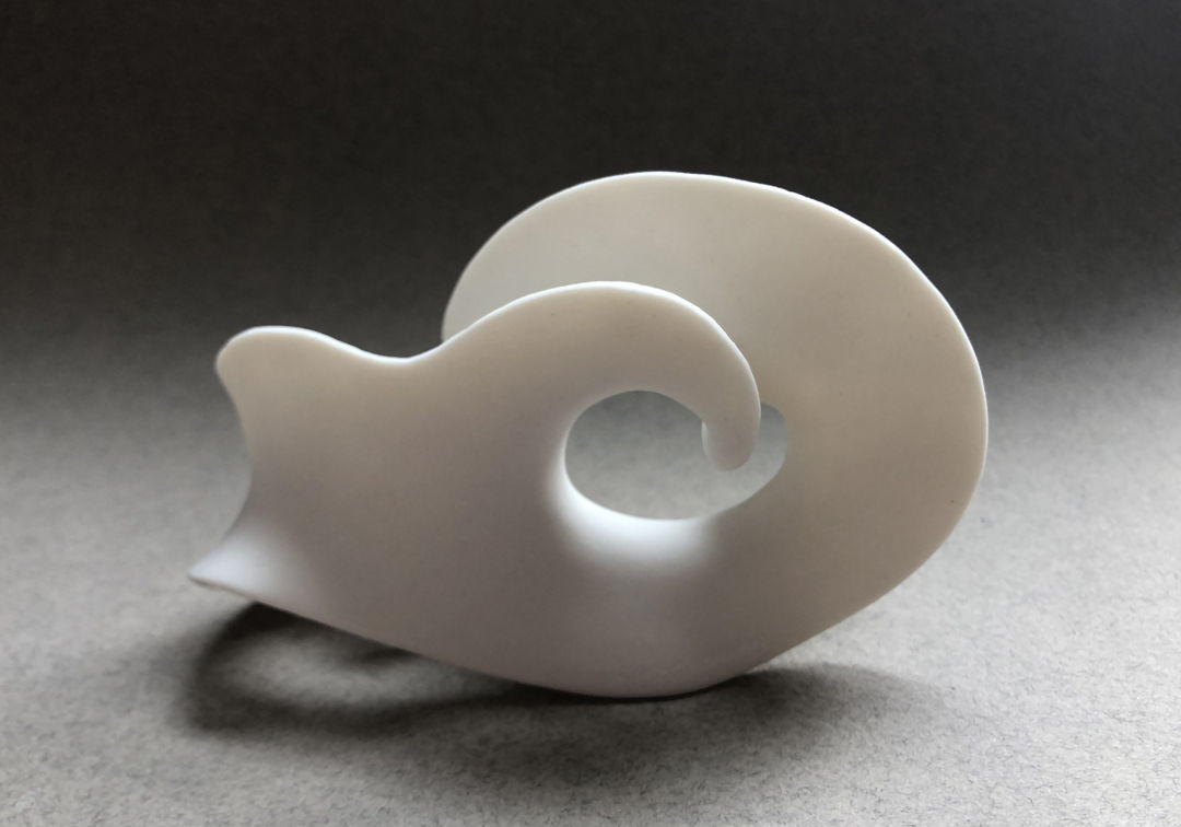 This high fired porcelain piece was created by pinching  cutting  twisting  and handbuilding. It has an unglazed surface.