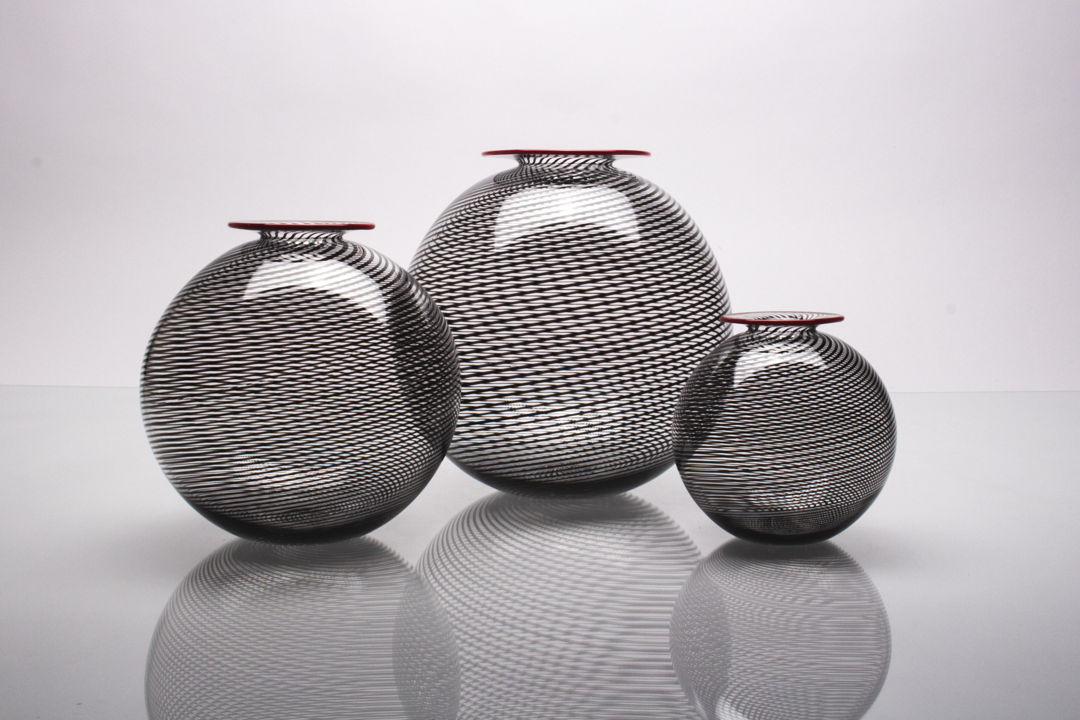 Three sizes of mezza filligrani cane with red lip wrap.