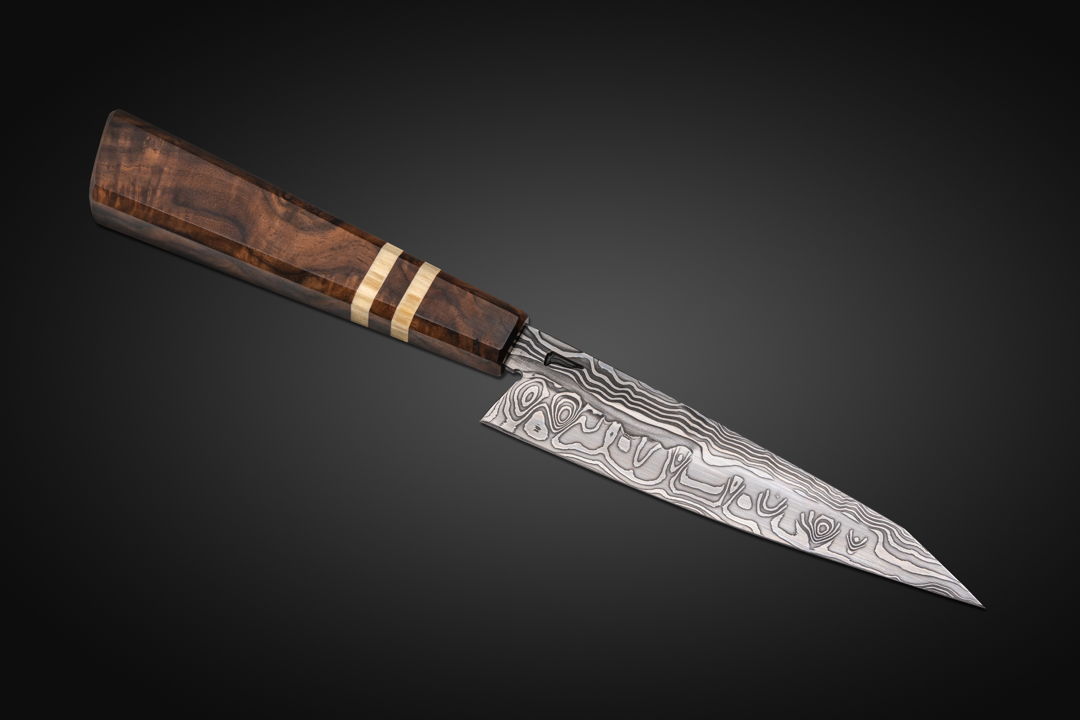 Another Petty (Utility) knife  this one in Damascus that I diffusion bonded from 26C3 and 15N20 steels. The handle is Turkish Walnut with American Aspen accents.