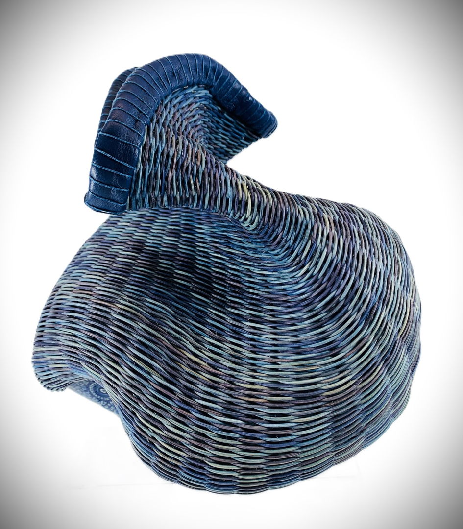 Hand-built pottery base woven with dyed reed and leather.