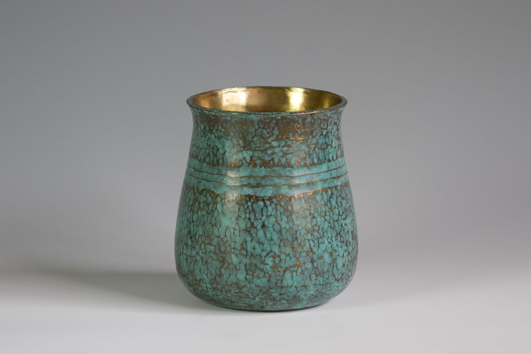 This brass vase is hammered out of a thick plate of 1/8" brass  stretched and then raised into a volumetric form.