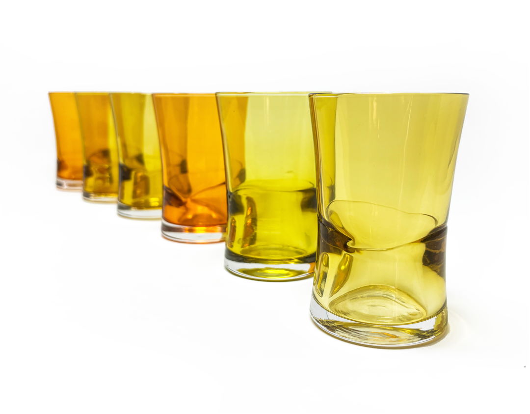 Low tide flight glasses with thick optic base and pinched waist form. Perfect for juice or a flight sampler. 7oz pictured in 3 separate colors creating a sunset set.