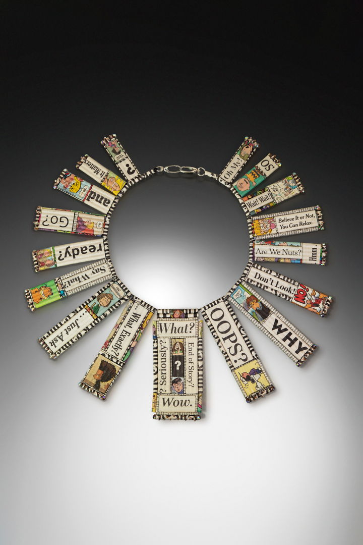 Recycled Newspaper Comic Strips and various USA Today  New York Times  Washington Post  Wall Street Journal and Indianapolis Star News Headlines are hand-formed into beads and hand-strung together into the form of a neckpiece. Swarovski Crystal beads and Japanese Glass Seed Beads are stitched to the surface of many of the newspaper components. Sterling Silver clasp