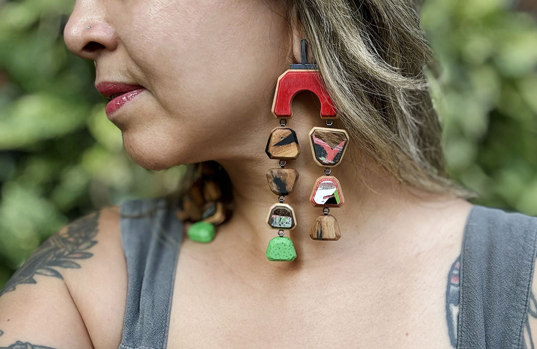 hand-cut tamarind hardwood and upcycled skateboards with hand fabricated oxidized sterling silver