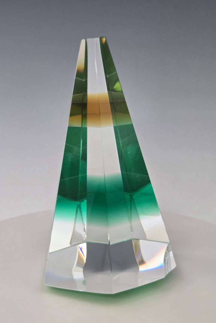 Cold-worked kinetic glass  wobbles around on pencil point base.
