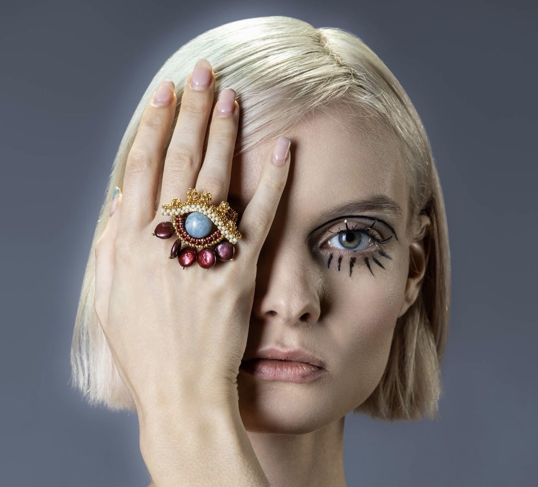 This series is inspired by the theme of the Evil Eye  and the handwoven ring comes in fine 24K gold plated seed beads  water pearls and aquamarine. This is a limited edition collection  available in various sizes and colors.