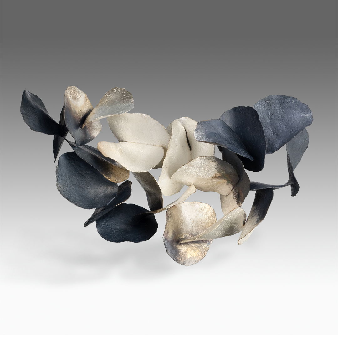 Made of sterling silver. Hammered  oxidized and constructed.