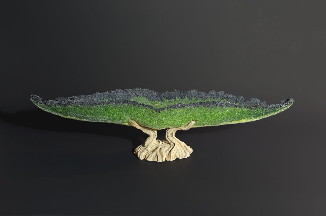 Hand-carved ceramic base with cast glass vessel