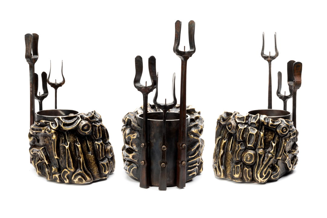 another piece in he engorged Eden series  the main body is made of brass and stainless steel with a polished rim and the candle holders are forged steel