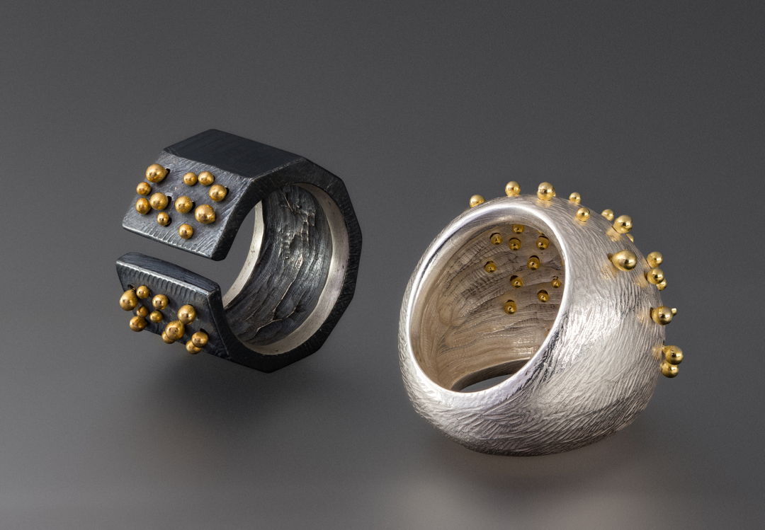 carved sterling silver rings pinned through with 18k gold balls
