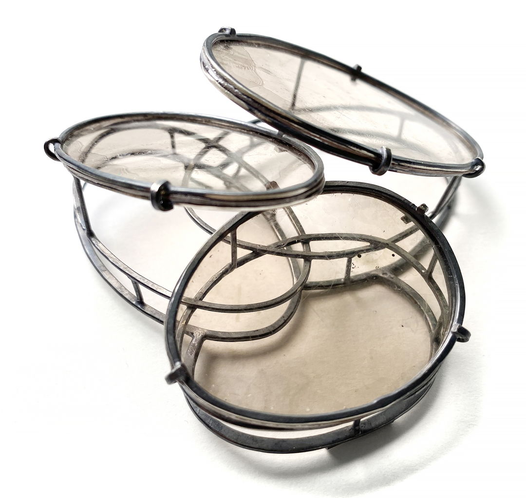 Handmade oxidized sterling silver chain is manipulated to build the platform for natural mica to be set. The simplicity of the ovals gives an architectural reference. The mica is set at angles to catch the light while wearing the brooch.