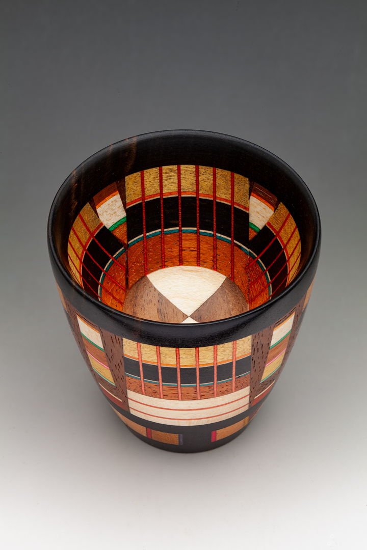 The Odyssey series is a new endeavor  combining different lamination techniques is a single piece. A colorful vessel with 8 different specie of wood and dyed Maple veneer.