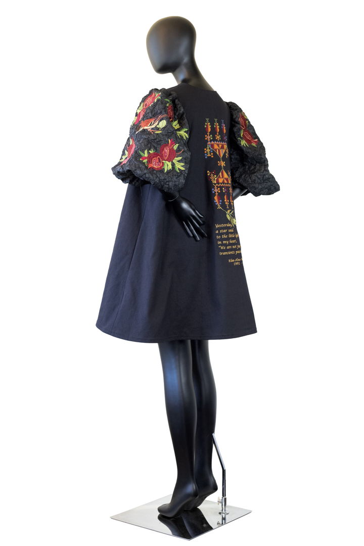 A-line short coat constructed with mill end fabrics. Custom embroidery incorporates an authentic Palestinian pattern and a poem by Hiba Abu Nada (1991-2023).