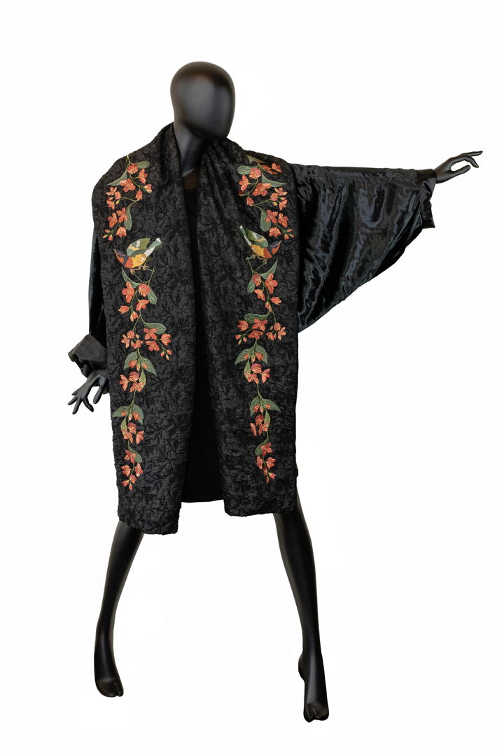Cocoon coat constructed using mill end and vintage fabrics. Created to honor the ongoing struggle of women in Iran and Kurdistan. Embellished with custom embroidery and the resistance slogan Women - Life - Freedom written in English and Arabic calligraphy.