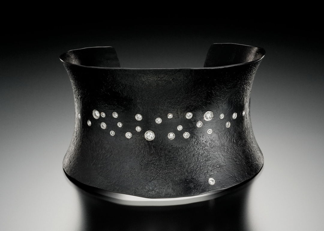 Hand-forged iron cuff with diamond sprinkle set in platinum. 18k gold name plate on inside.