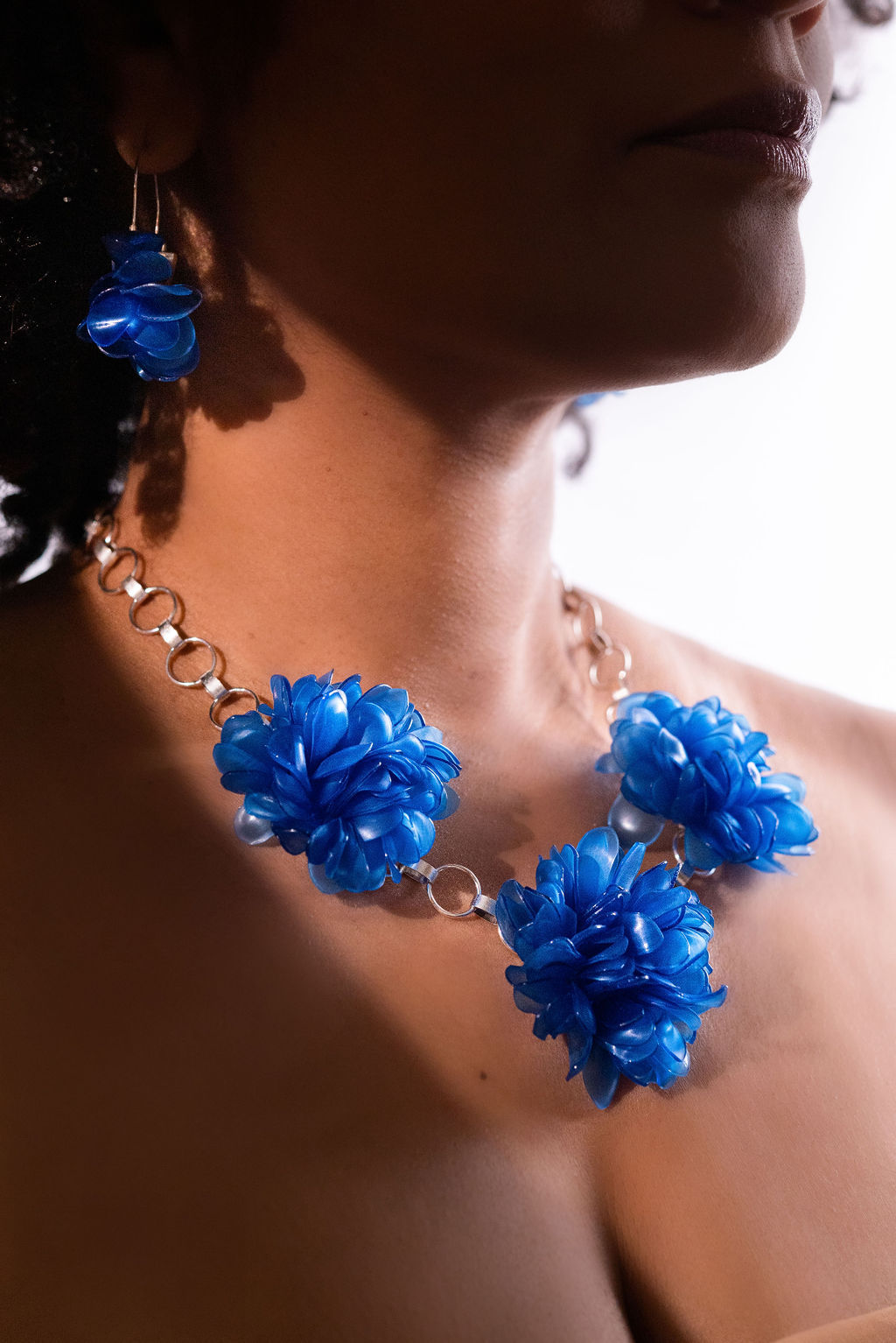 Matching earring and necklace set with clusters of blue beads