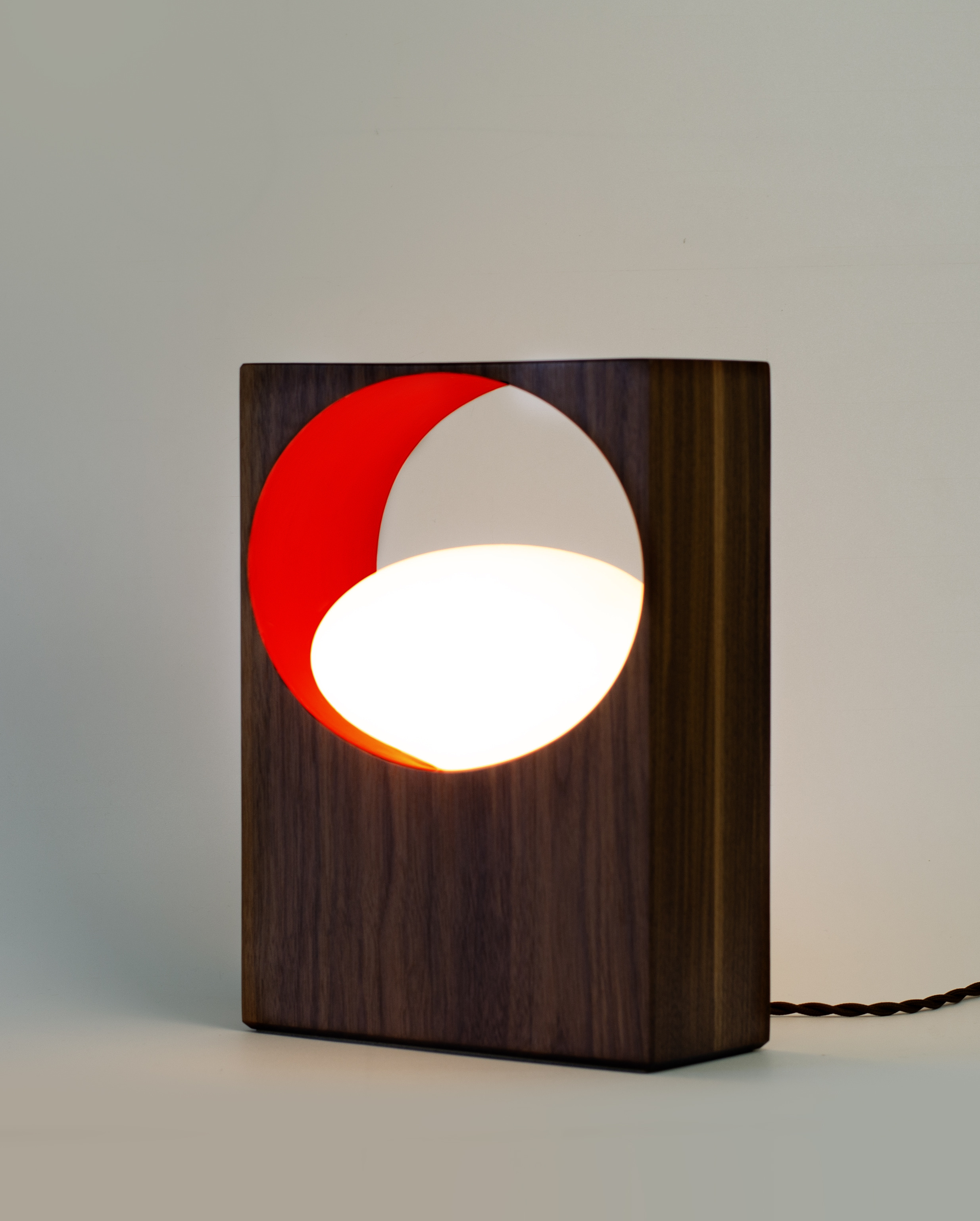 modern wood lamp with light coming from circular negative space