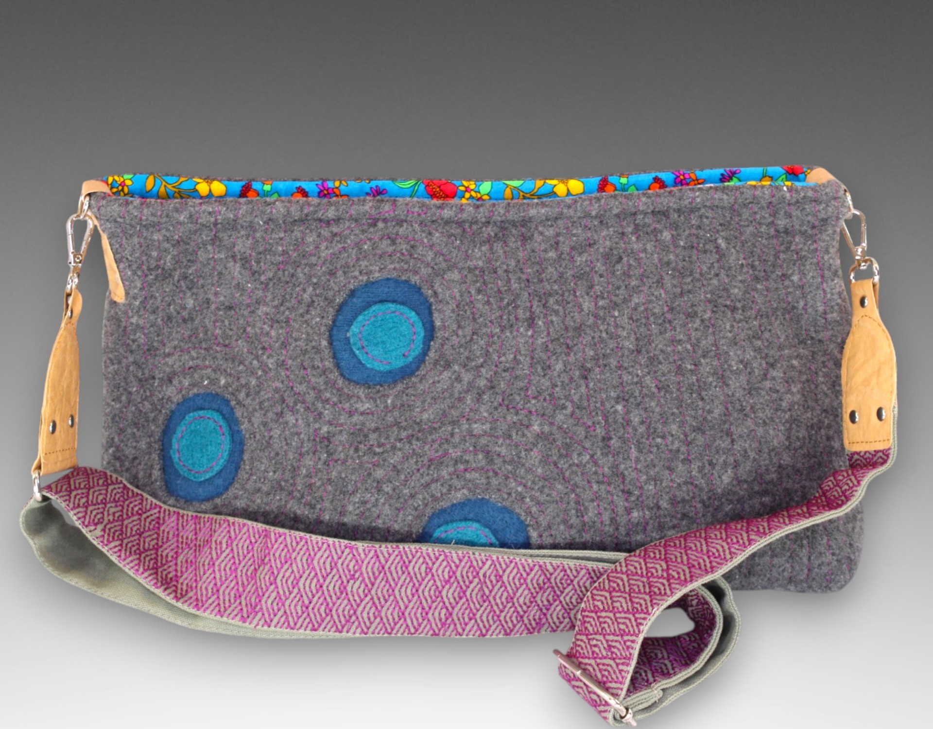 purse with three circles and a purple strap