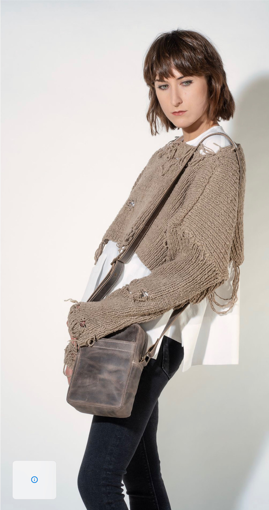 model with leather purse and short distressed sweater
