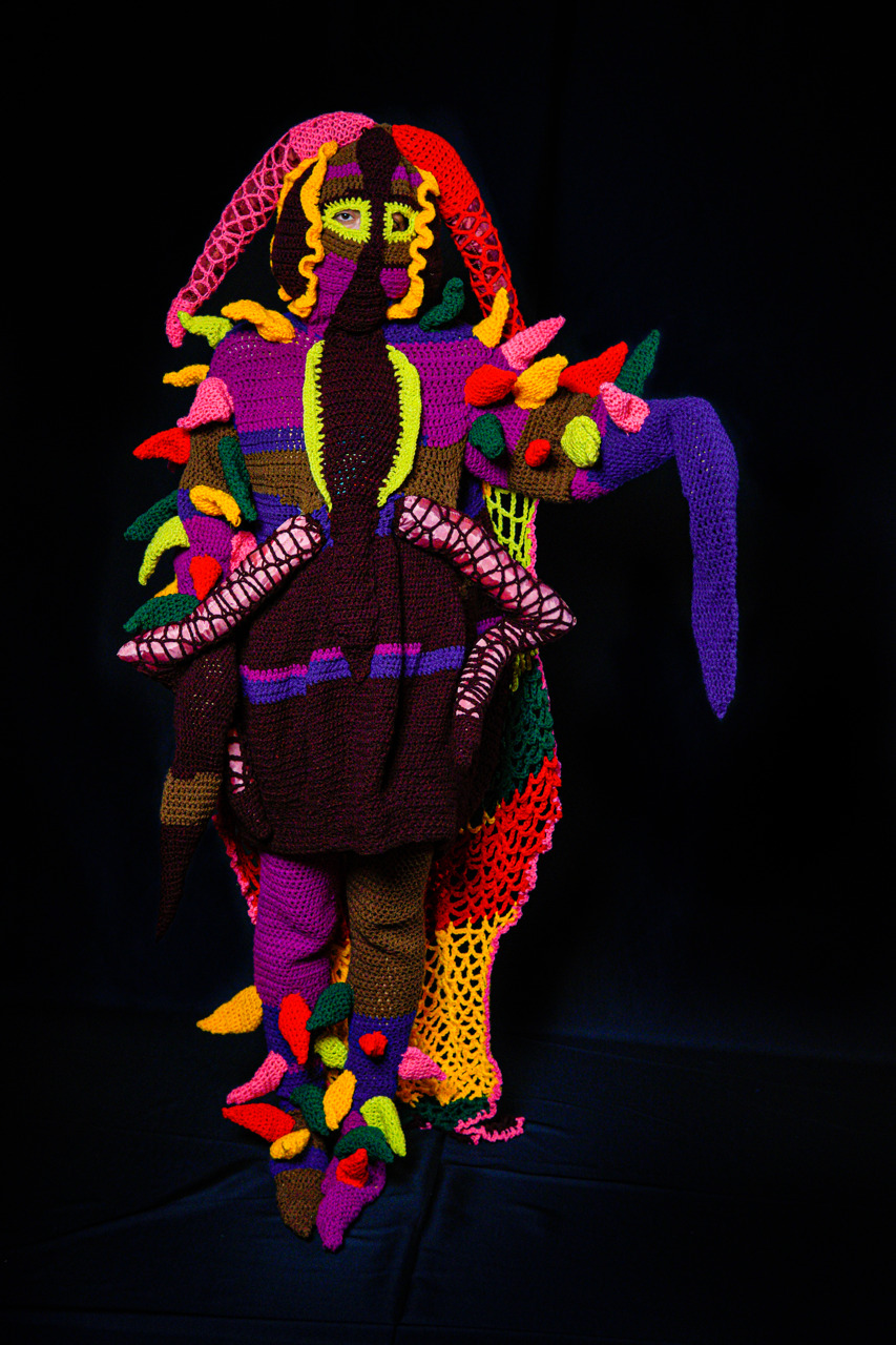 full body suit of bright colors on black background