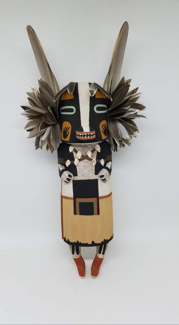 The badger Kachina is a symbol of strength  healing and protection. He is most commonly seen during the winter night dances. The badger kachina is carved from aged dried cottonwood root  painted with all natural mineral earth paints that I hand collect and process myself. Duck feathers  quail feathers and shells are used to complete the badger kachina.