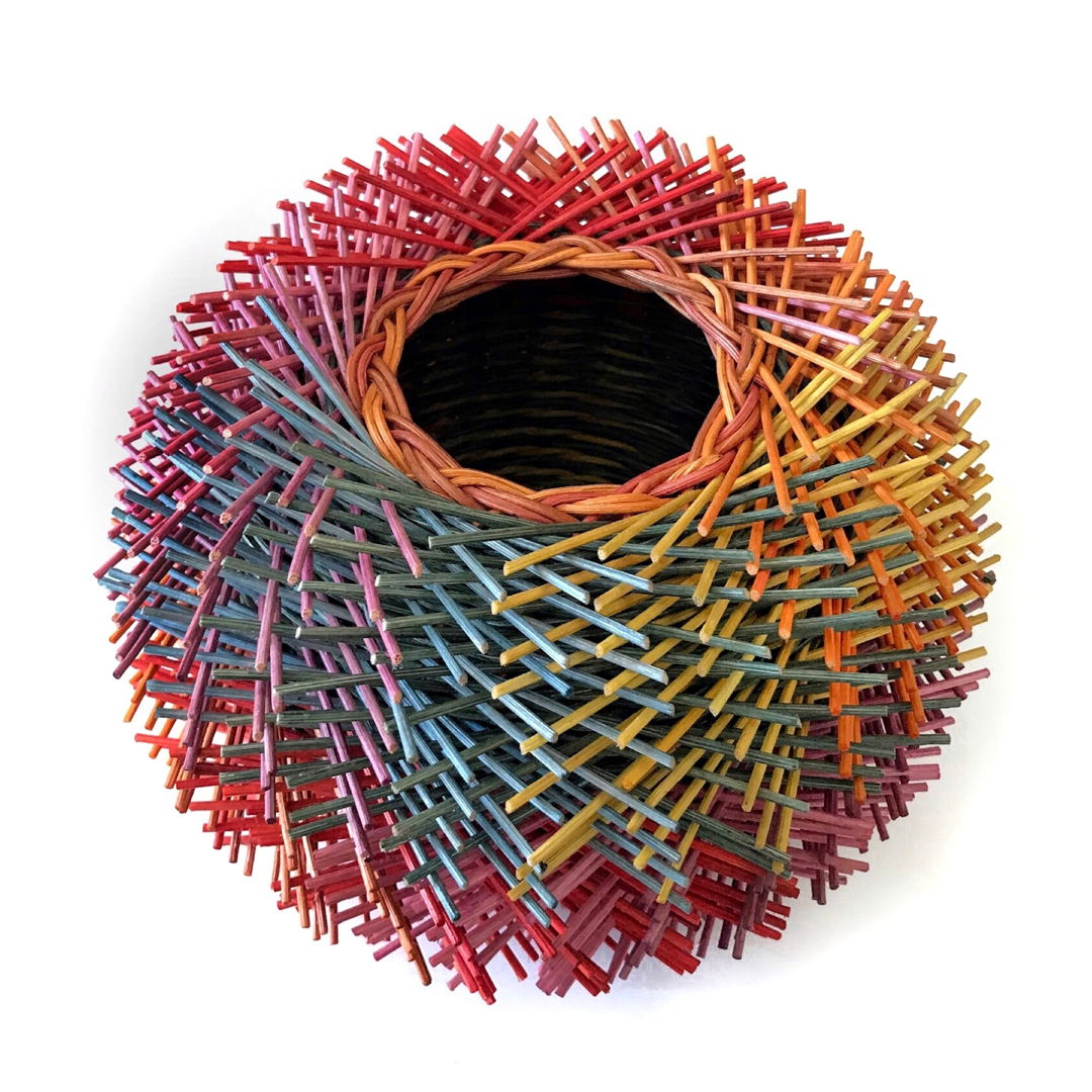 100's of short pieces of rattan are woven into the walls of the basket to create the artist's own "hairy" technique. (I’ve dyed all colors you see.) Encaustic medium was applied  then melted into the reed to strengthen and protect the finished basket.