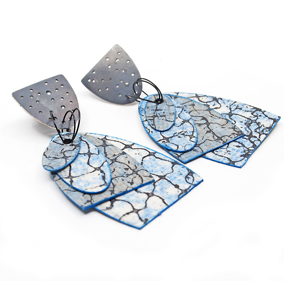 Earrings made of washable paper (cellulose + synthetic latex) printed on an etching press with soy-based archival inks; and oxidized sterling silver. These earrings have sterling silver posts and ear nuts.