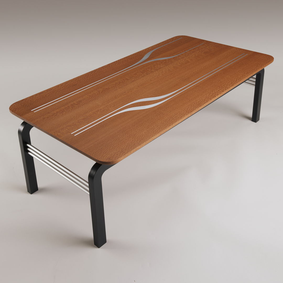 The stunning beauty of Australian lacewood contrasts with sleek  asymmetrical aluminum inlays. The curved corners of the floating top are repeated in the base of ebonized beech. A trio of anodized aluminum rods echoes the aluminum inlay. Limited edition of 6