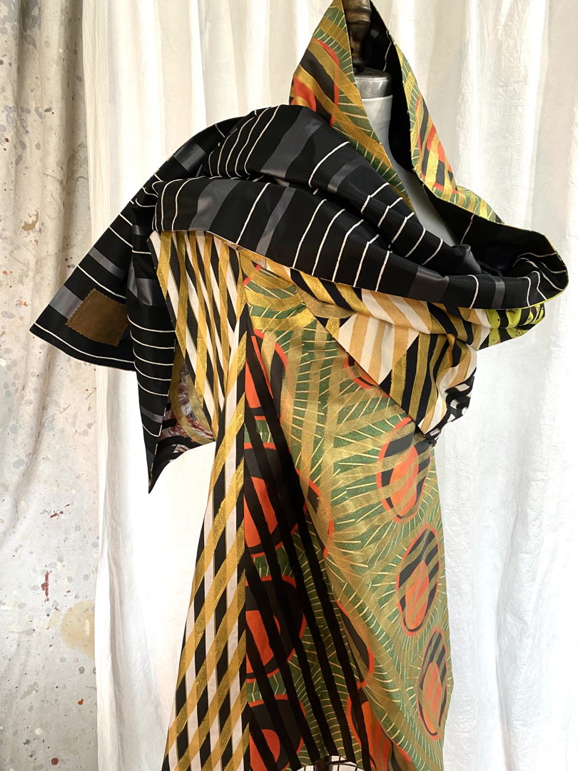 Every inch of fabric is hand painted with graphics done with a 3/8" brush. The result is mesmerizing on both solid and woven patterned fabric. This piece is all cotton  and is washable.