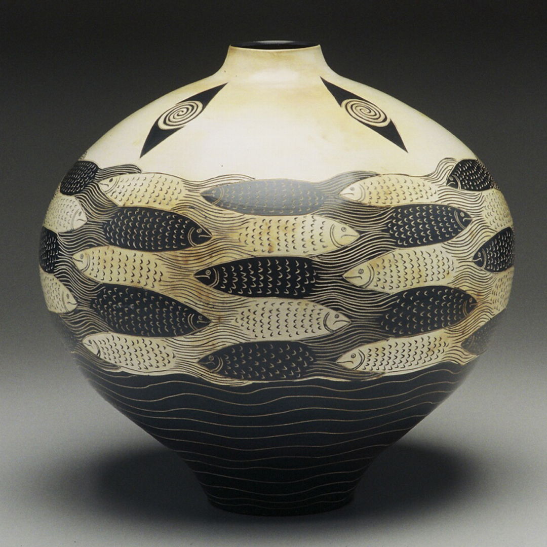 vase depicting black and white fish interlaced.