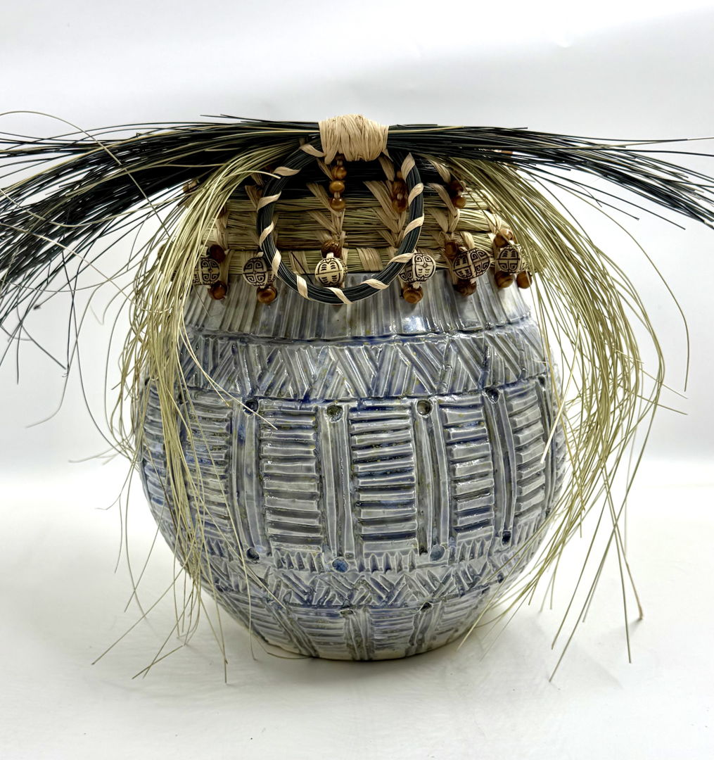 Wheel thrown ceramic vessel intricately carved  South Carolina Coastal sweetgrass attached  also wooden beads help align the combination of both art forms.
