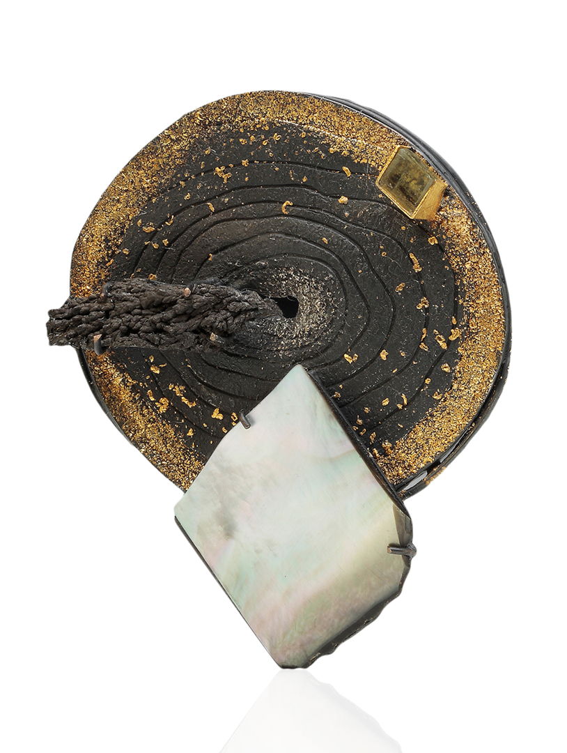 An exquisite fusion of platinum  24k &amp; 22k gold  sterling silver  aquamarine  and mother-of-pearl mineral. Crafted through chasing and fusing techniques  it embodies elegance and artistry.