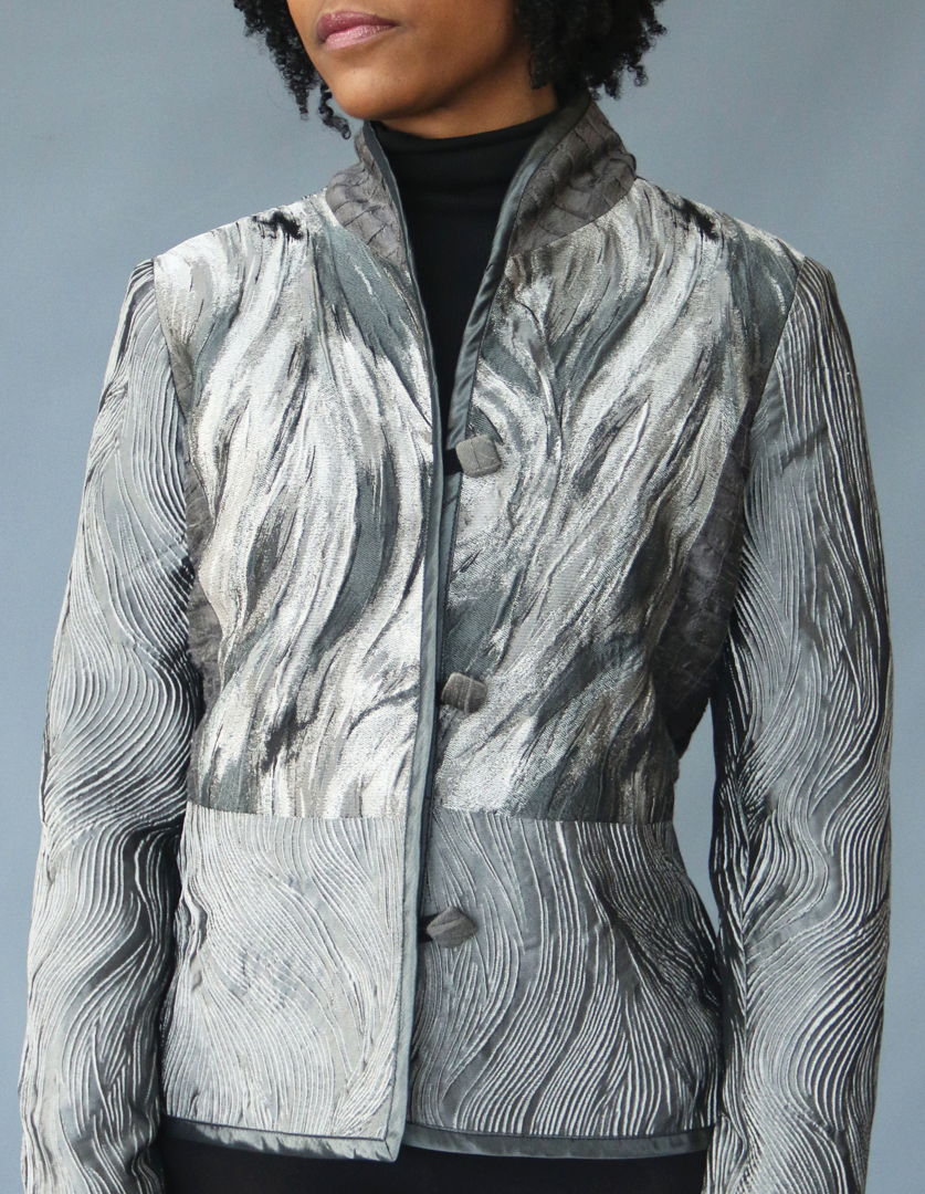 Bethal jacket- pieced of various textures Pieced jacket of iridescent  textured silk with coordinating bias  collar and matching handmade buttons.